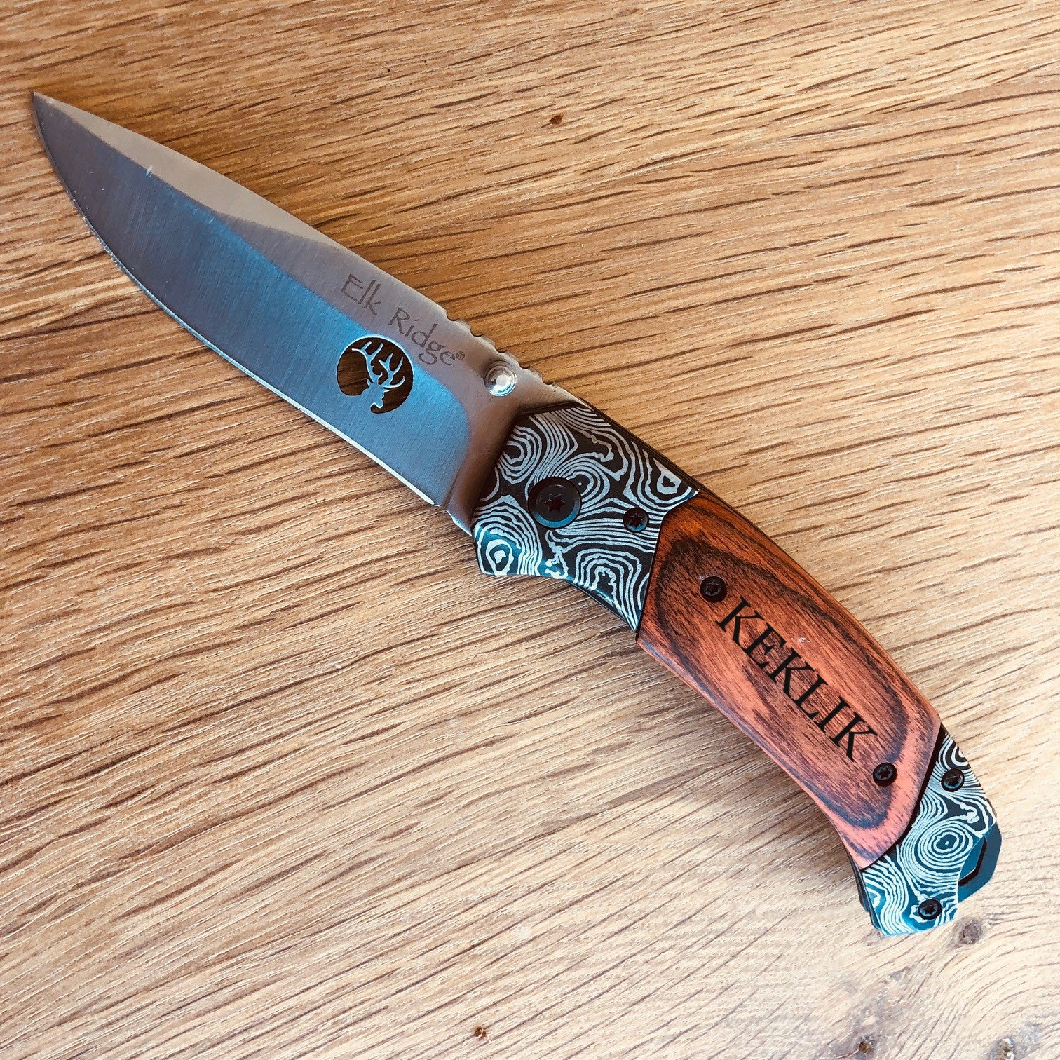 Engraved Damascus-style folding knife with personalized wooden handle and custom wooden gift box option.