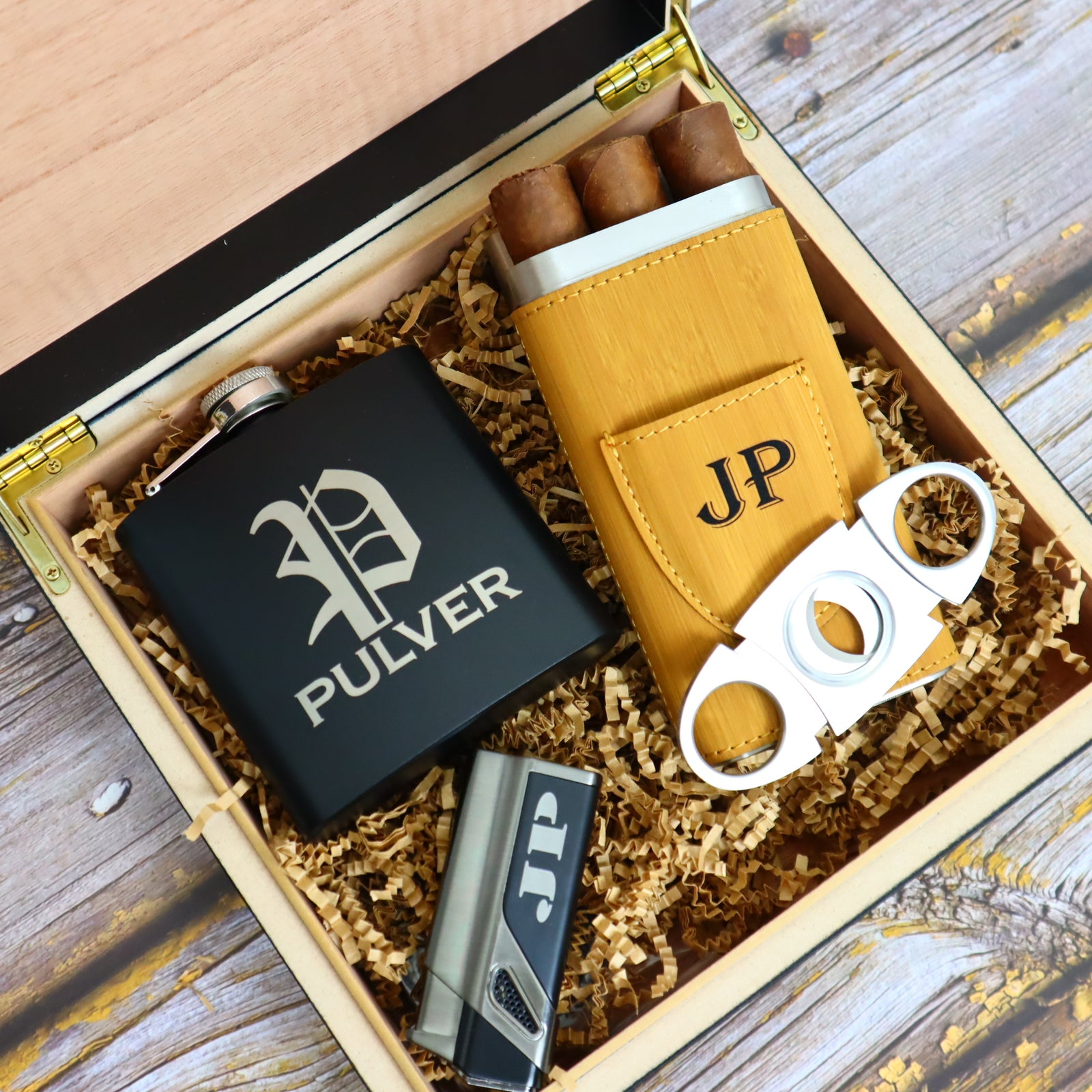 Luxury cigar and whiskey gift set with personalized humidor, flask, lighter, and cigar accessories