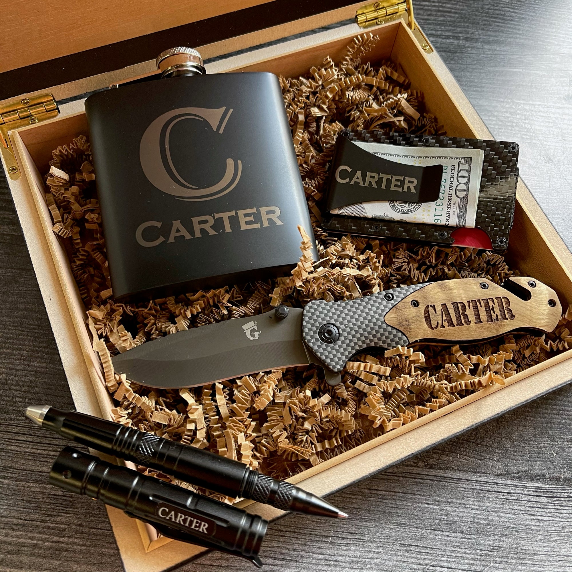 Personalized tactical gift box set for men with engraved flask, money clip, and tactical pens, presented in a custom wooden gift box.