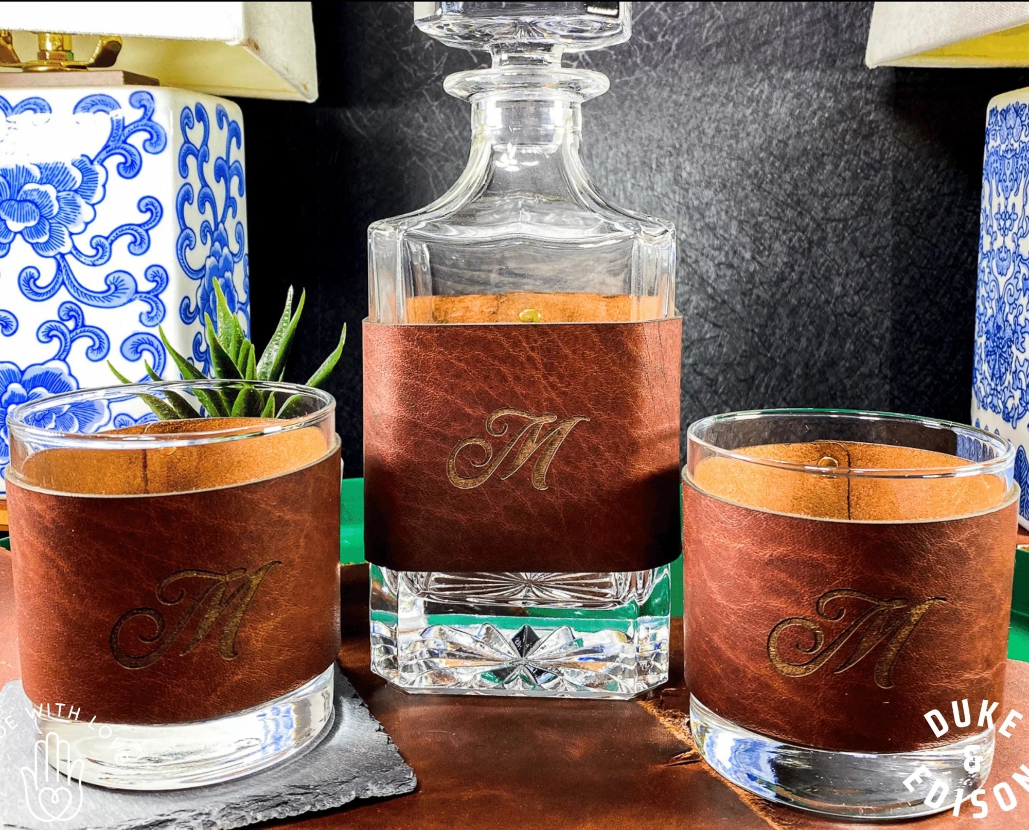 https://www.groovyguygifts.com/cdn/shop/products/duke-edison-groomsmen-custom-stylized-initials-leather-wrapped-decanter-and-whiskey-glass-set-38359791993063_2000x.webp?v=1656598672